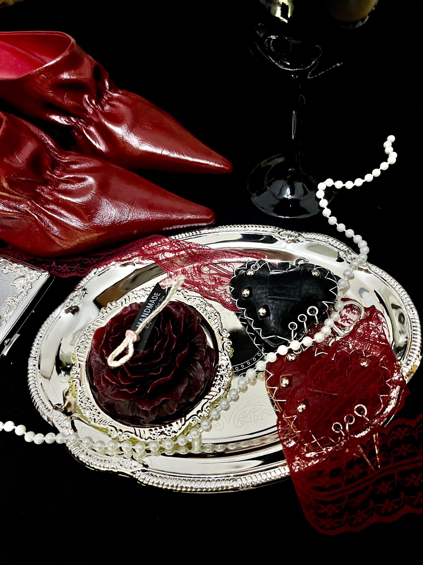 Red heels, silver tray and candle Fashion Objects still life